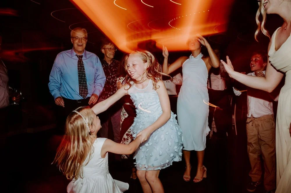 Two young girls dancing hand in hand at Kylie and Will's reception