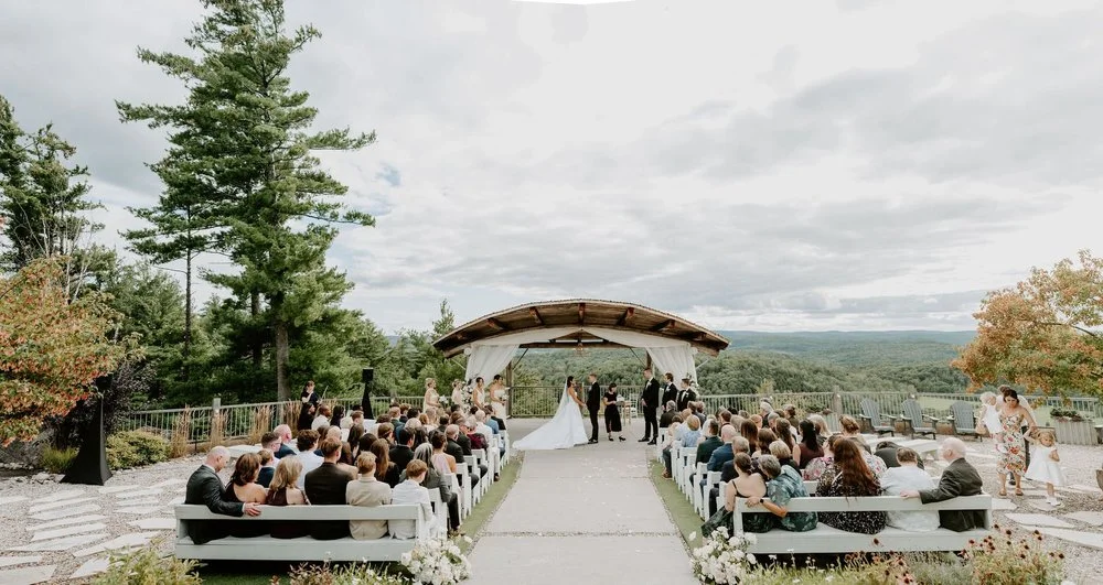 Wide view of Kylie and Will's outdoor ceremony at Le Belvedere in Wakefield, with guests facing the hilltop pavilion