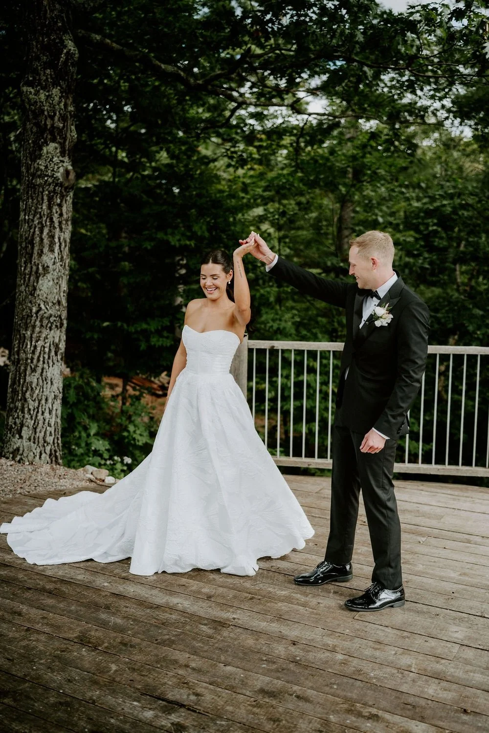 Will twirling Kylie on the wooden deck among tall trees at Le Belvedere in Wakefield