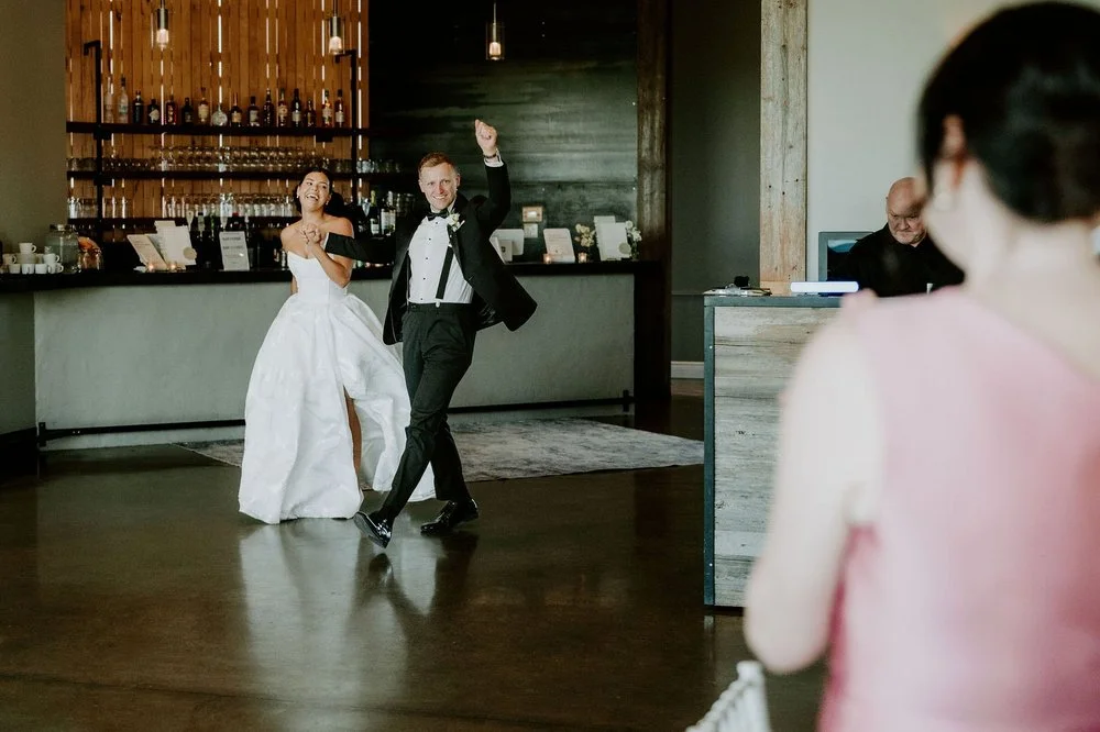 Kylie and Will making their grand entrance into the reception, Will punching the air