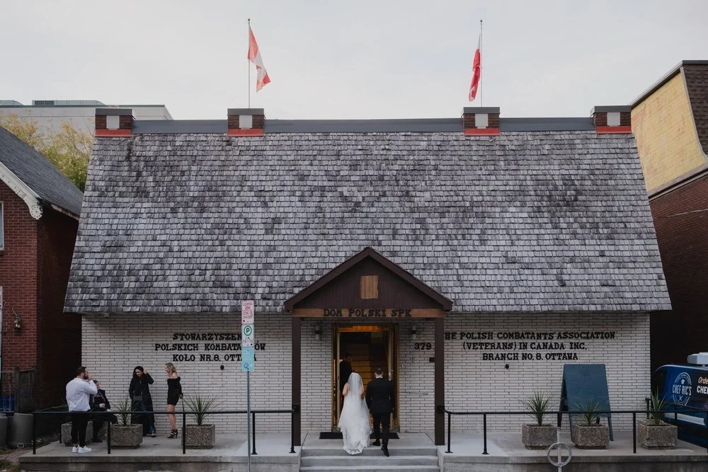 bride and groom walking into their reception hall for their wedding ceremony