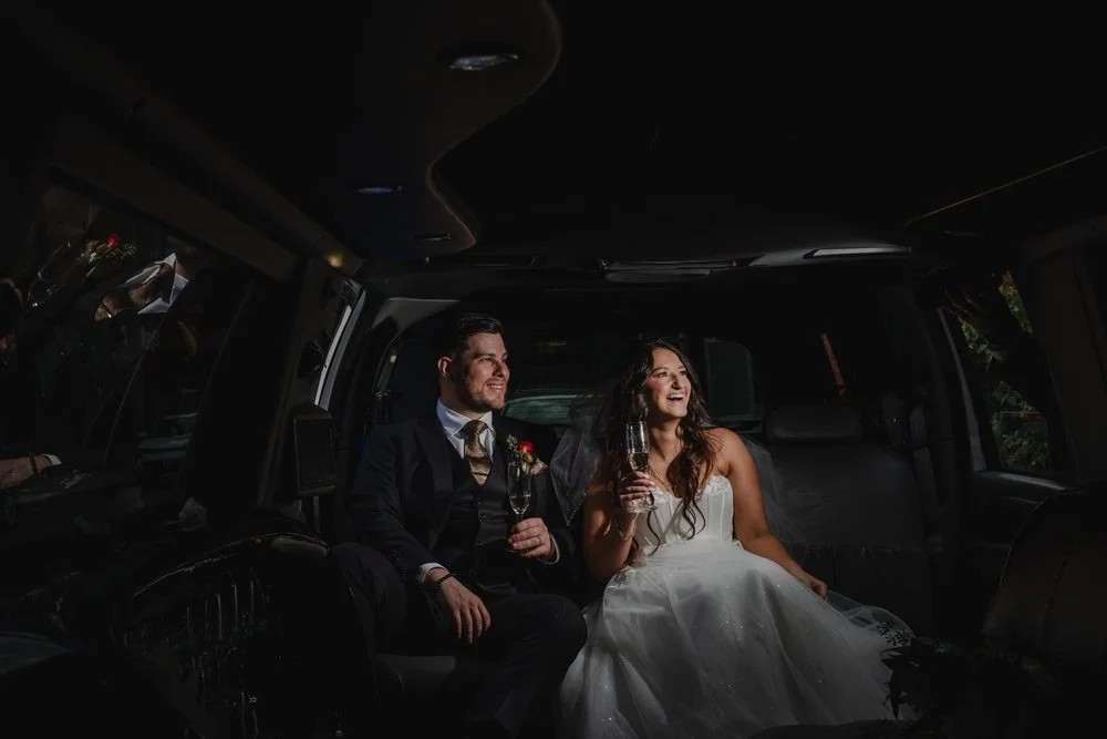 photo of a bride and groom inside a limo
