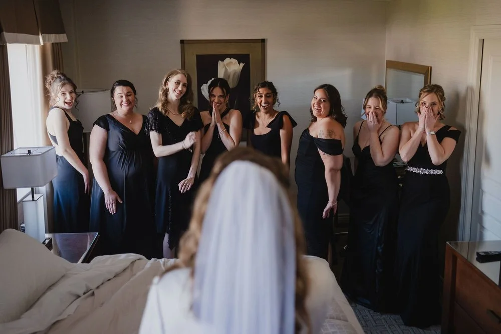 photo of bridesmaids reacting to seeing the bride for the first time.