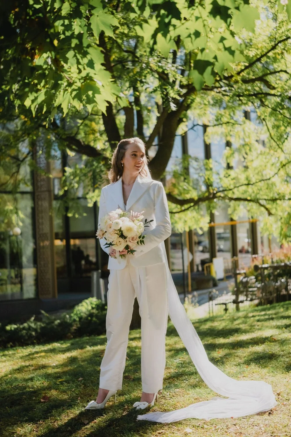 photograph of a bride in a white suit