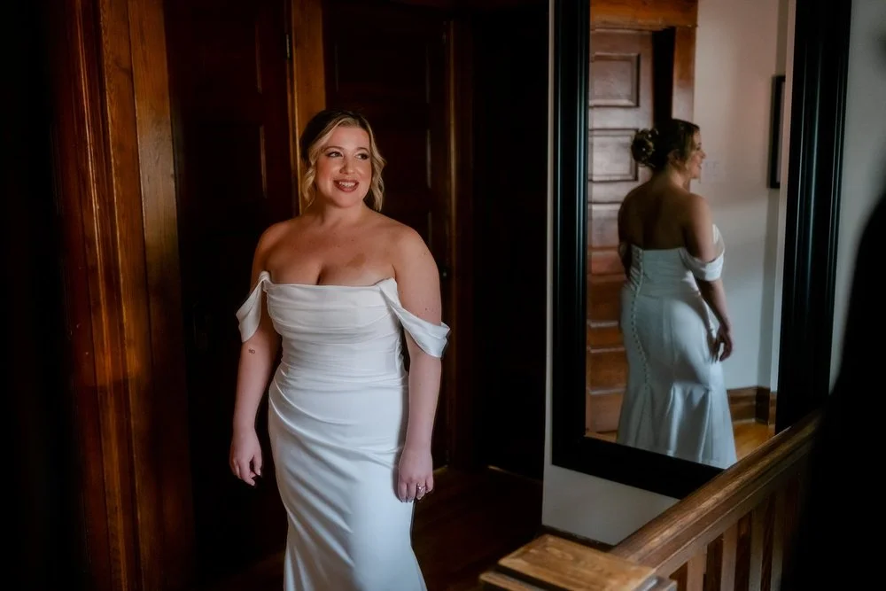 a photo of a bride getting into her wedding dress