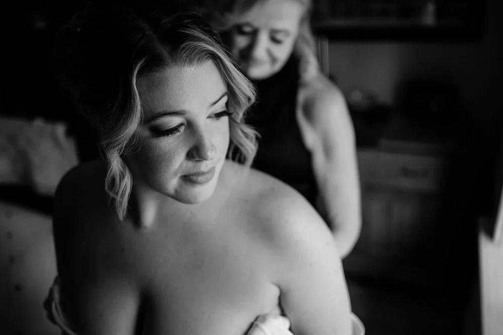 a bride getting into her wedding dress
