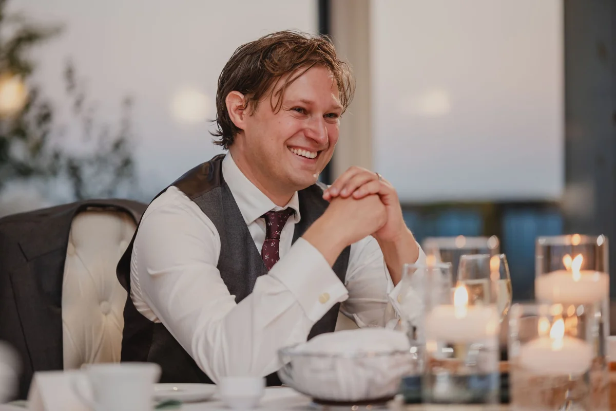 groom enjoying a speech at a le belvedere wedding reception