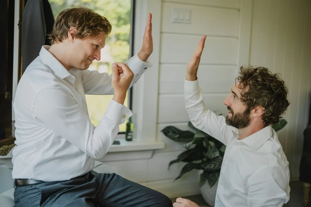 a groom and groomsmen high-fiving