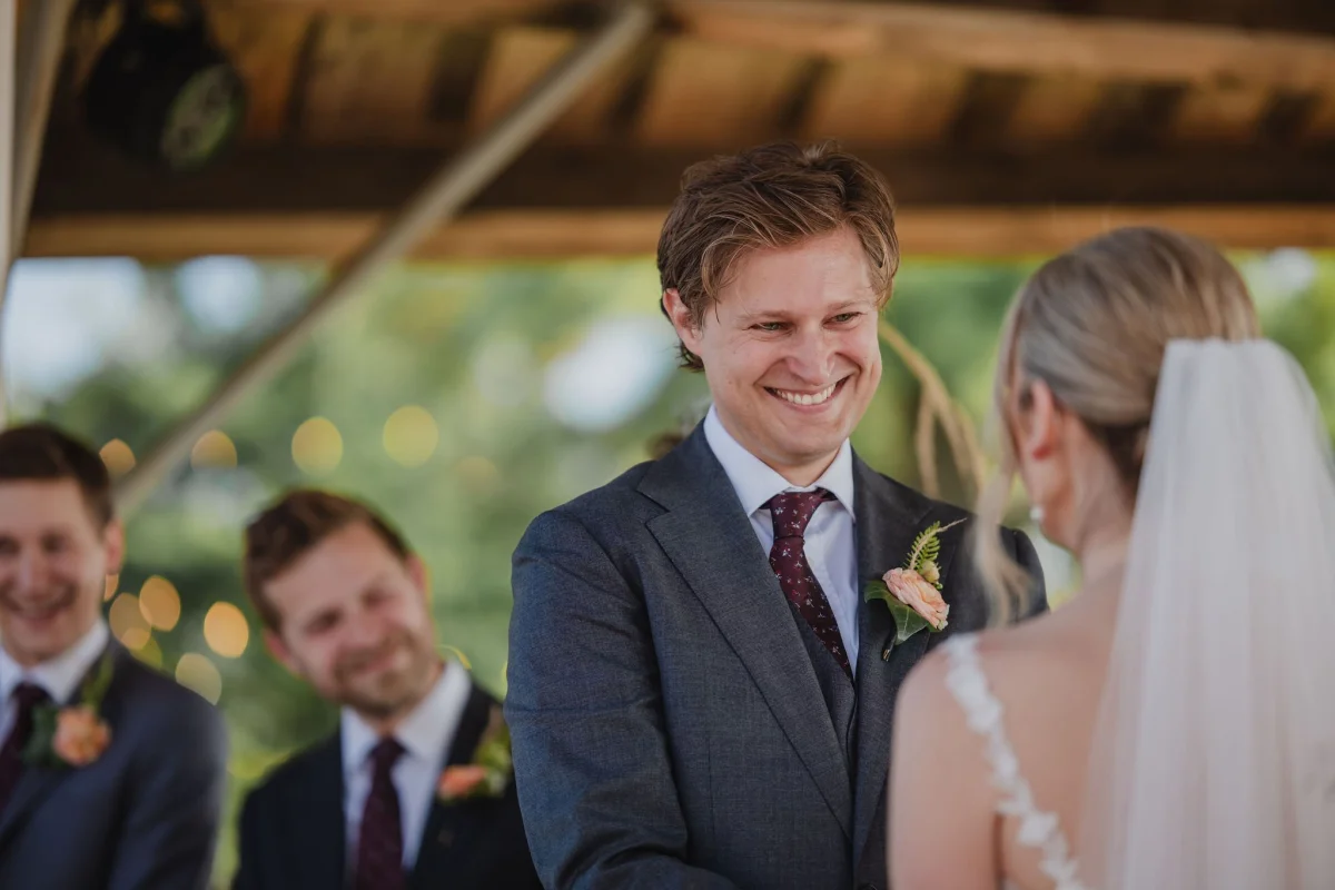 groom smiling at his bride candid photographs from a wedding ceremony at le belvedere