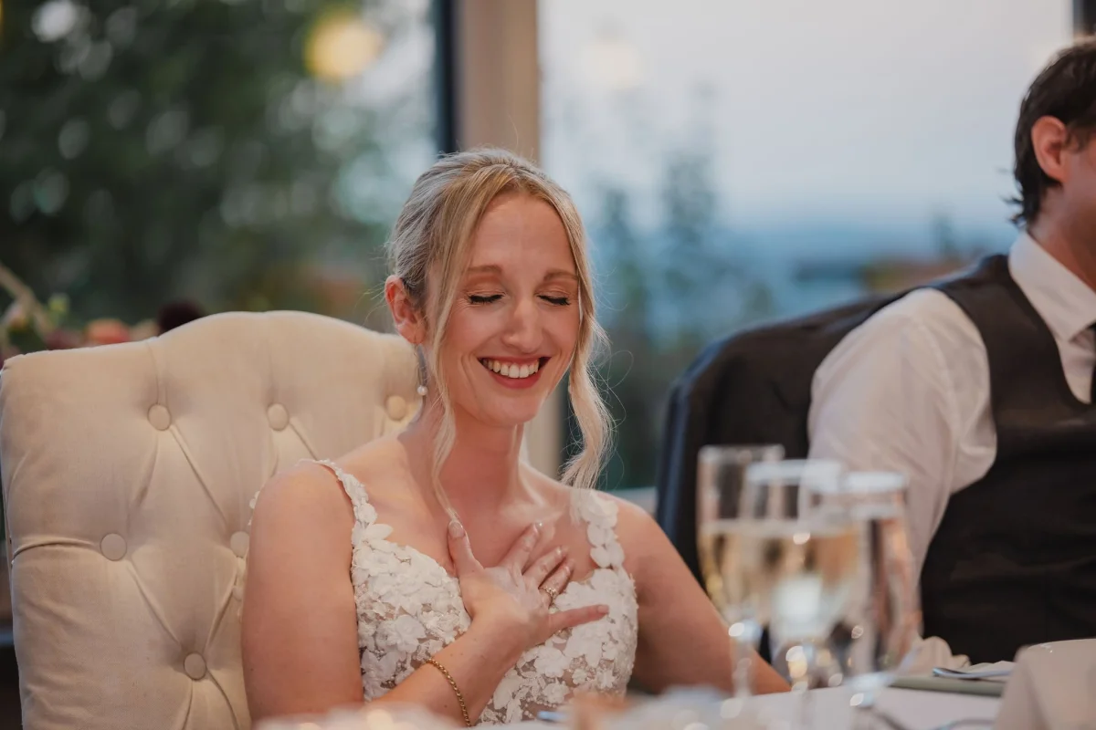 bride laughing at a speech