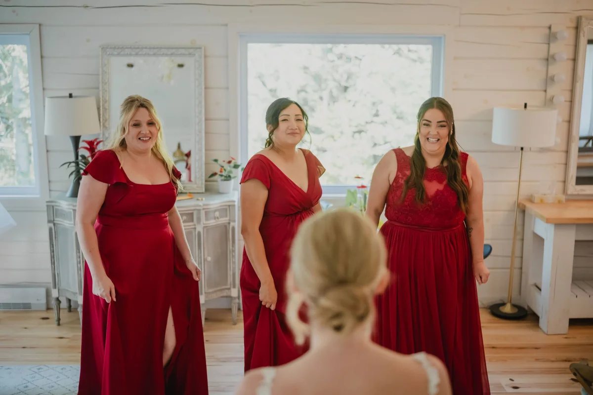 bridesmaids seeing the bride in her wedding dress for the first time