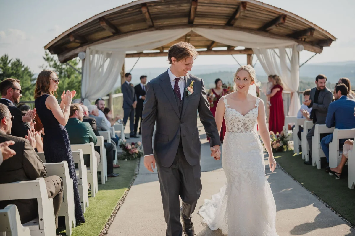 bride and groom walking back down the aisle at le belvedere