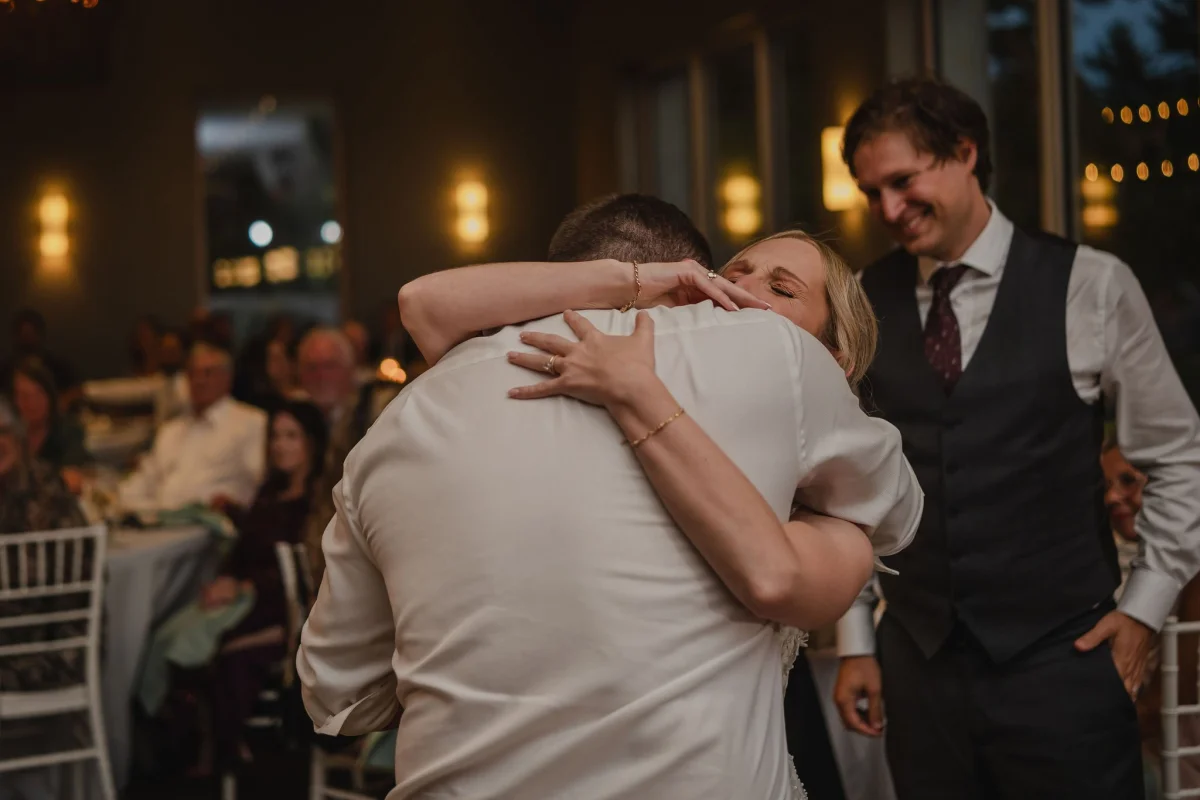 bride hugging a wedding guest