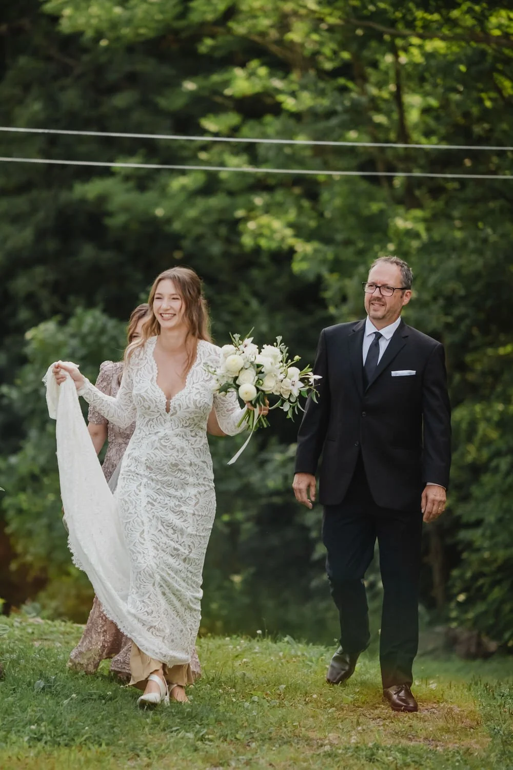 a photograph of a bride walking to her wedding ceremony