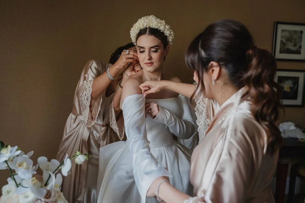 bride getting into her wedding dress in a suite at the chateau Laurier in ottawa