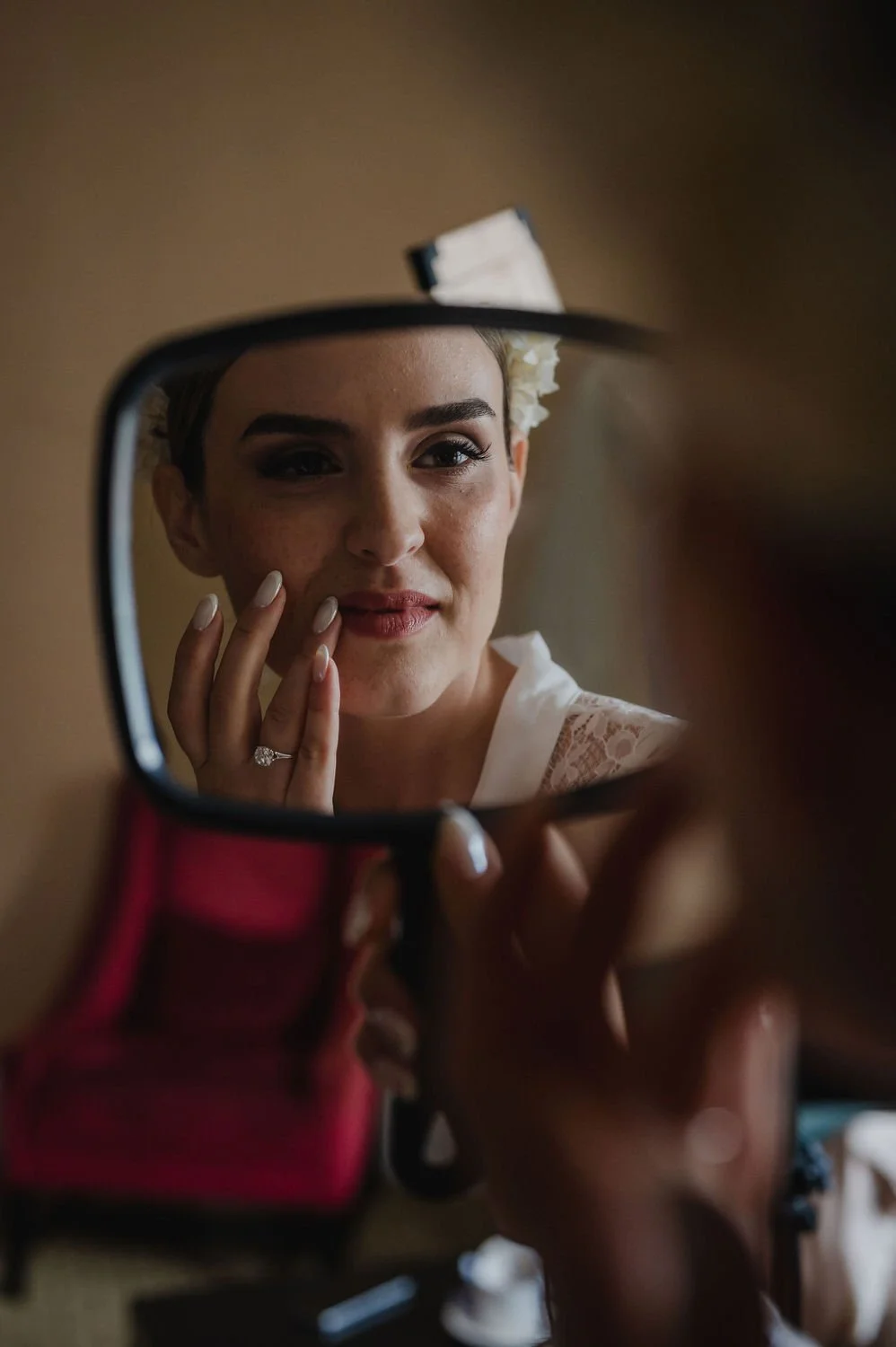 photograph of a bride getting her makeup done inside a suite at the chateau laurier