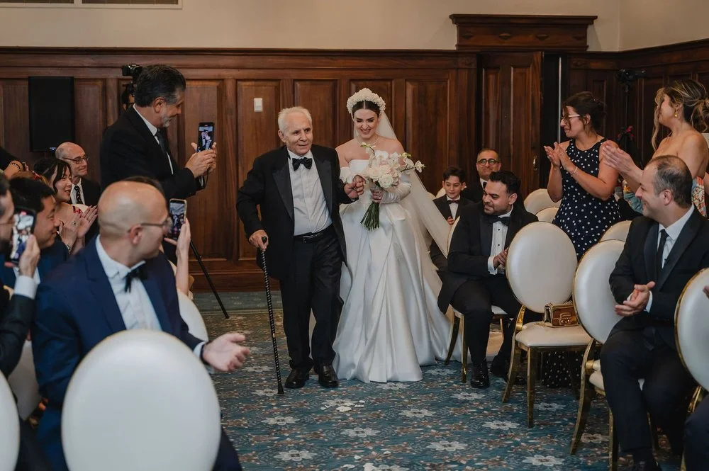 photo of a bride walking down the aisle at the chateau laurier