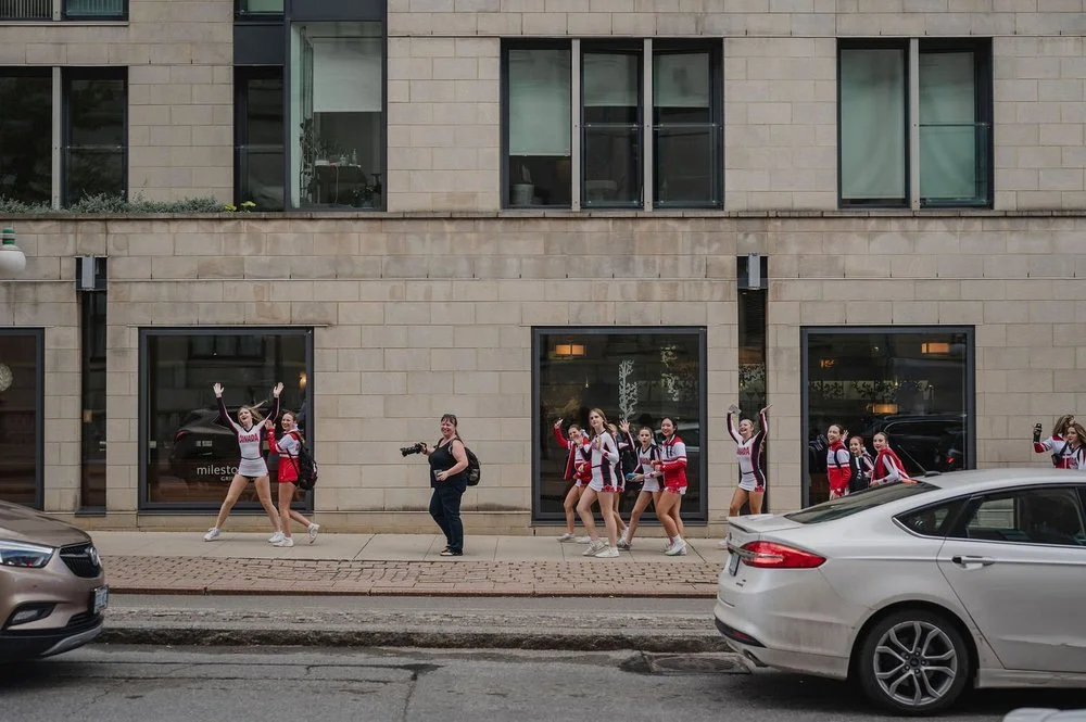 funny photo of a cheer leading squad cheering a recently married couple