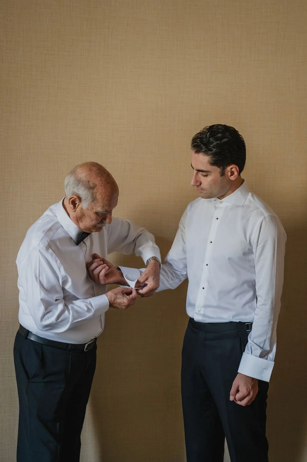 photograph of a groom getting ready for his wedding at the chateau laurier