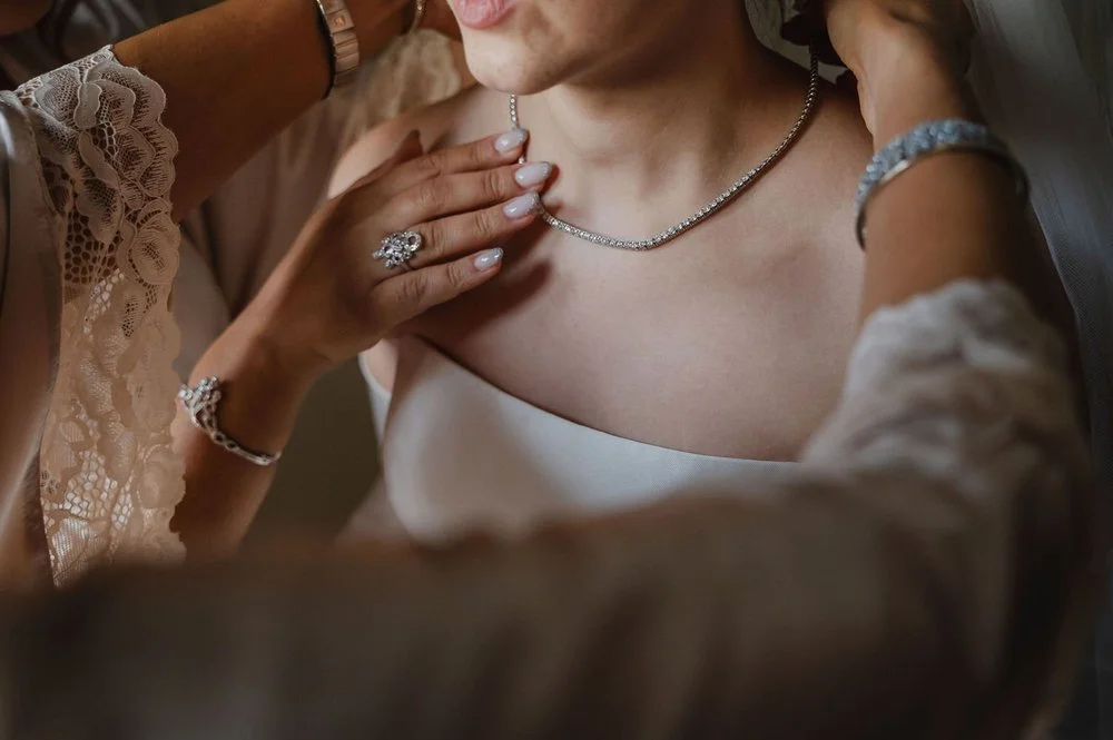 bride getting into her wedding dress in a suite at the chateau Laurier in ottawa