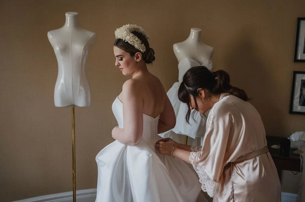 bride getting into her wedding dress in a suite at the chateau Laurier in ottawa