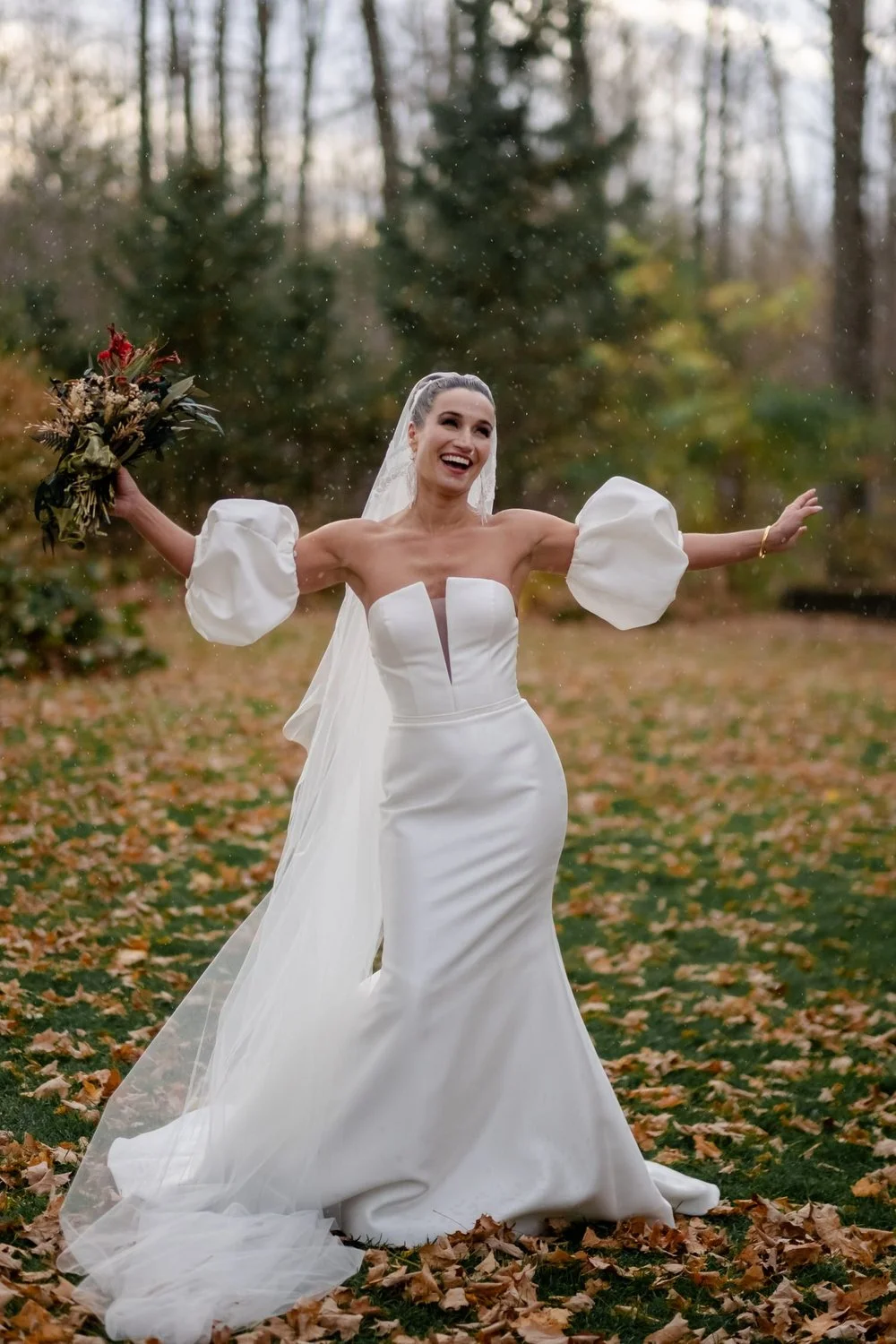 bride laughing in the rain