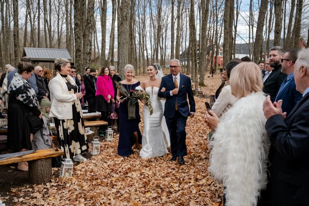 bride walking down the aisle at autumn wedding ceremony photograph at Temple's Sugar Bush in fall
