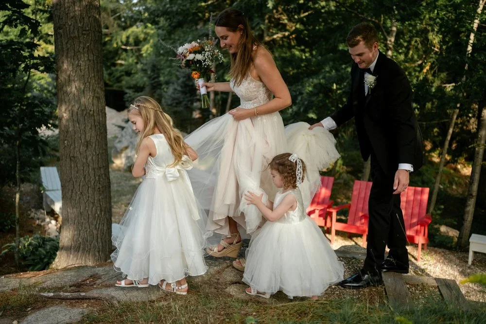 candid photograph of a bride and her flower girls