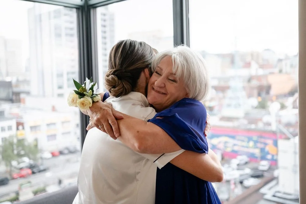 A bride hugging her mother