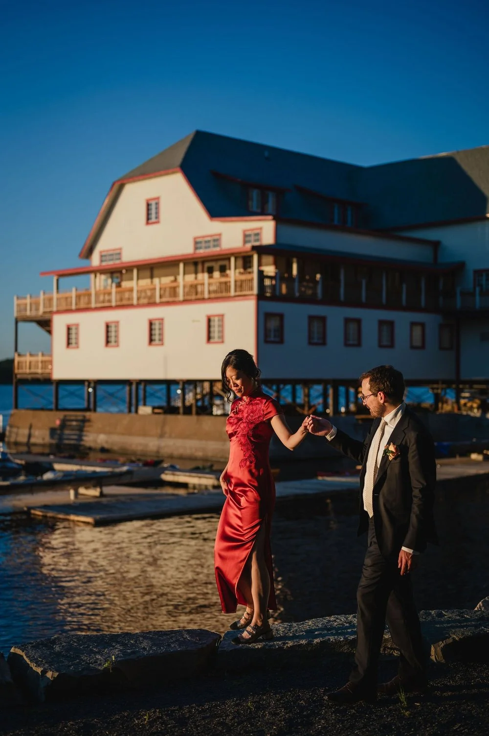 a bride and groom portrait outside the wedding photographs outside the NCC River House at sunset in Ottawa