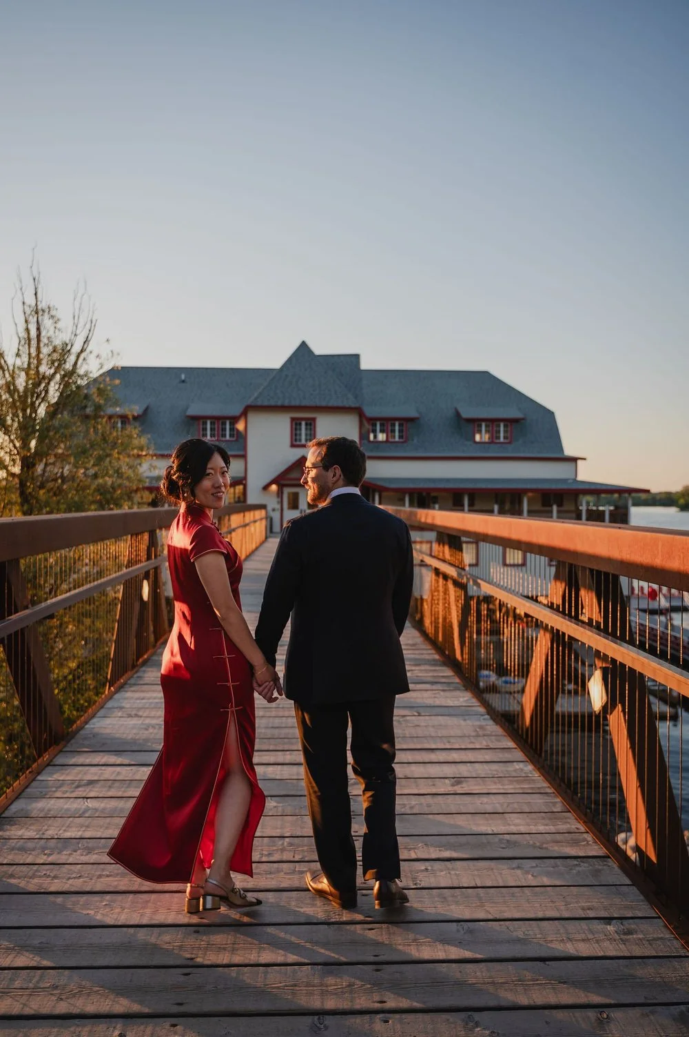 a bride and groom portrait outside the wedding photographs outside the NCC River House at sunset in Ottawa