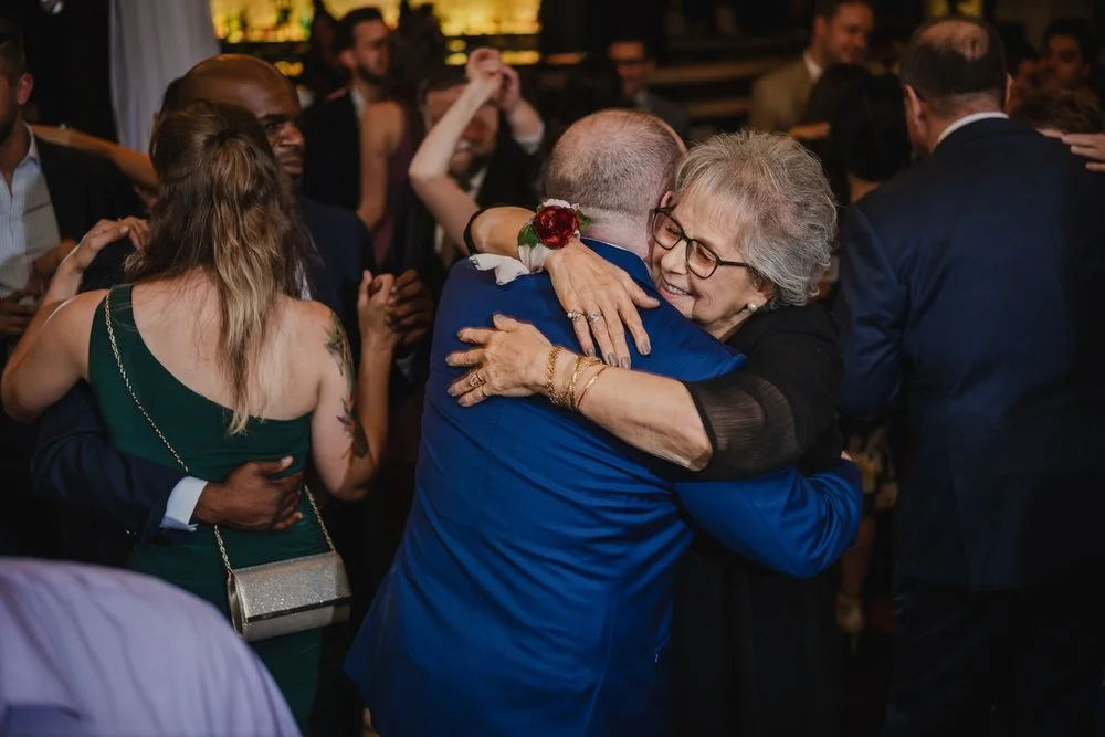 a groom hugs his mother on the dance floor at a wedding reception at Lago in Ottawa