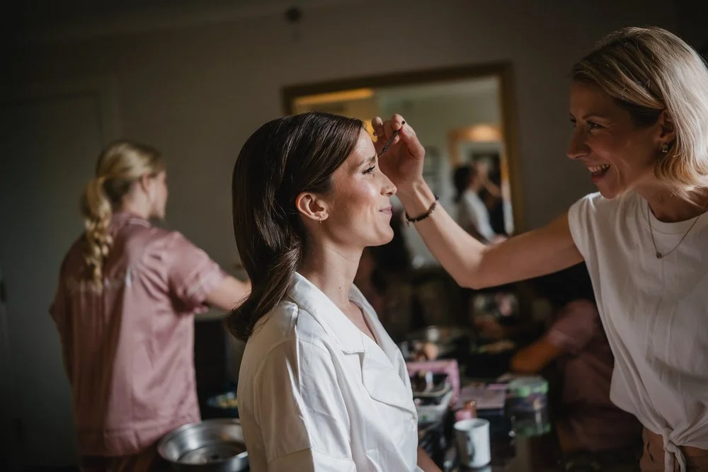photograph of a bride getting her makeup done