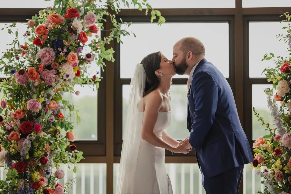 Photo of a first kiss at a Lago wedding