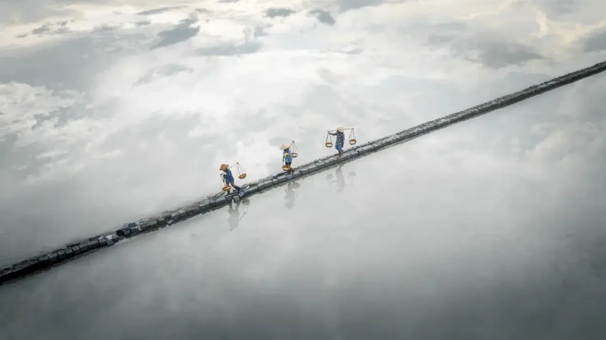 Workers in salt pools in Vietnam.